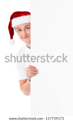 Happy smiling young man in Santa Claus hat showing blank signboard, isolated on white background