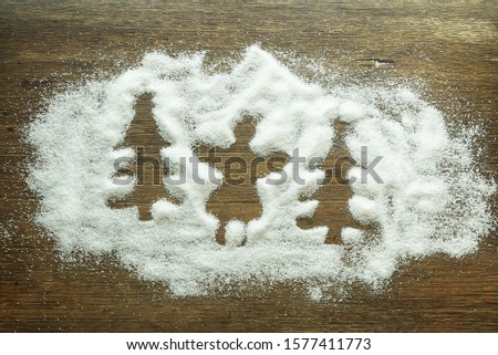 Top layout design christmas tree sihouette on the snow with wood background