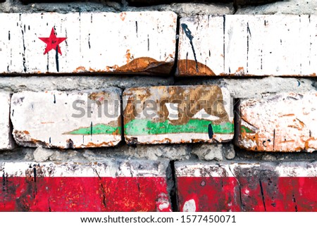 California grunge, damaged, scratch, old style united states flag on brick wall.