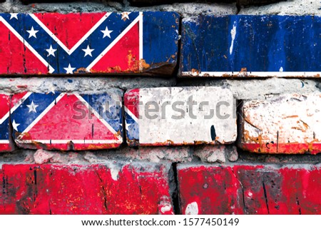Mississippi grunge, damaged, scratch, old style united states flag on brick wall.