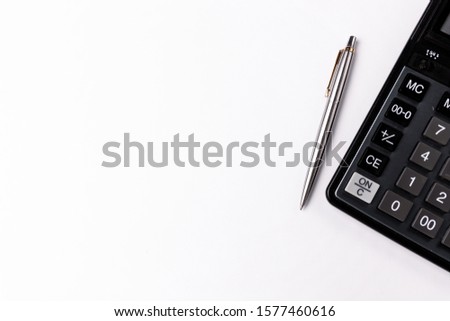 Calculator and pen isolated on white background Royalty-Free Stock Photo #1577460616