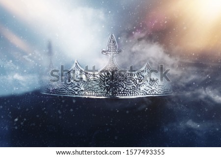 mysterious and magical photo of of beautiful queen/king crown over gothic snowy dark background. Medieval period concept Royalty-Free Stock Photo #1577493355