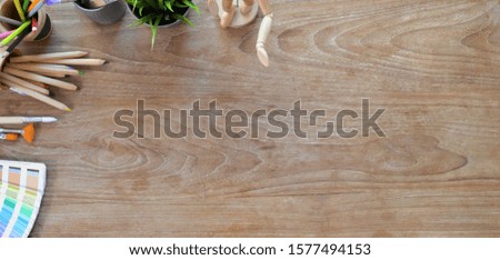 Top view of vintage designer workplace with office supplies and copy space on wooden table 