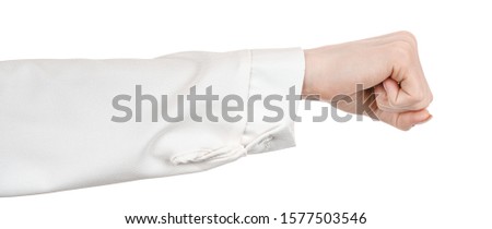 Female caucasian hands in a white office blouse, shirt isolated white background showing fist gesture. woman hands in business office style showing different gestures