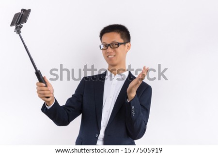 Young Asian male hands holding mobile phone in self portrait