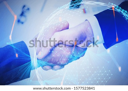 Two businessmen shaking hands in blurry office with double exposure of digital planet hologram and blurry network interface. Concept of partnership and hi tech startup. Toned image
