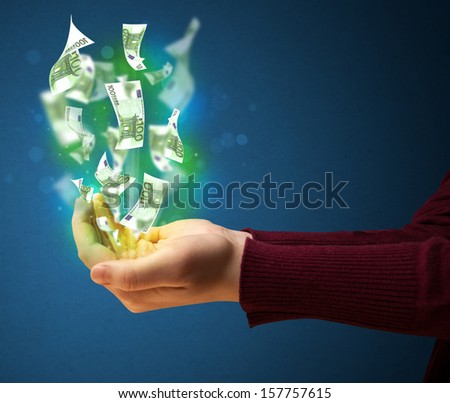 Woman holding glowing paper moneys in her hand