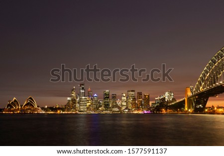 Beautiful view of the Sydney Harbour Bridge and the city at twilight with a sunset looking from Milsons Point in Sydney, Australia  