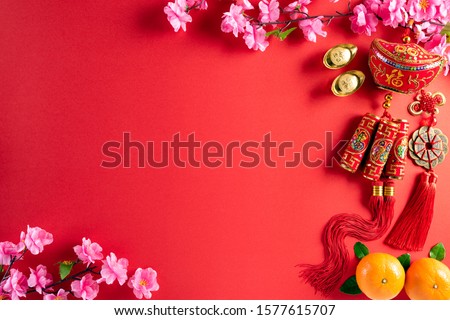 Chinese new year festival decorations pow or red packet, orange and gold ingots or golden lump on a red background. Chinese characters FU in the article refer to fortune good luck, wealth, money flow. Royalty-Free Stock Photo #1577615707