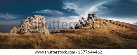 Mountain top with beautiful rocks and visible vehicle tracks. Dramatic sky.  Crimea, Demerji 
