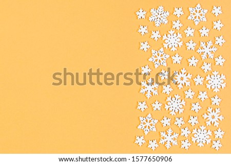 Top view of winter ornament made of white snowflakes on colorful background. Happy New Year concept with copy space.