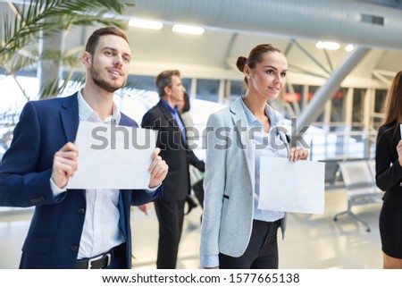 Business people with blank name tags for the guest to pick up as a service
