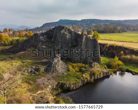 Drone view of the polygonal structures of basalt columns, also named Herrnhausfelsen, natural monument Panska skala near Prachen (Czech Republic). Basalt is a extrusive volcanic rock formed.