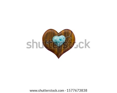 heart pendant made of bacout tree and larimar stone isolated on white background.