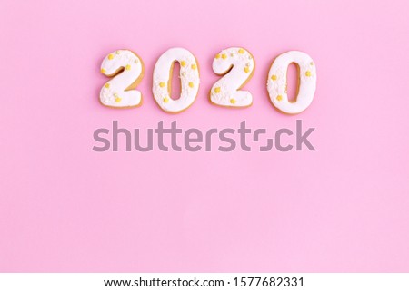 White gingerbread numbers in top of pink background with copy space.