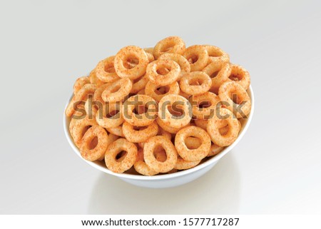Fried and Spicy Mini Ring Snacks or Fryums (Snacks Pellets) served in a white bowl. selective focus - Image Royalty-Free Stock Photo #1577717287