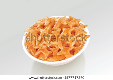 Fried and Spicy Aero Plane Snacks or Fryums (Snacks Pellets) served in a bowl or White background. selective focus - Image Royalty-Free Stock Photo #1577717290