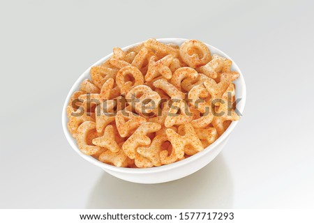 Fried and Spicy ABCD, Alphabet Snacks or Fryums (Snacks Pellets) served in a white bowl. selective focus - Image Royalty-Free Stock Photo #1577717293