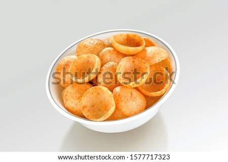 Fried and Spicy Moon Cup, Vatka, Katori, Moon Chips, Snacks or Fryums (Snacks Pellets) served in a bowl or White background. selective focus - Image Royalty-Free Stock Photo #1577717323