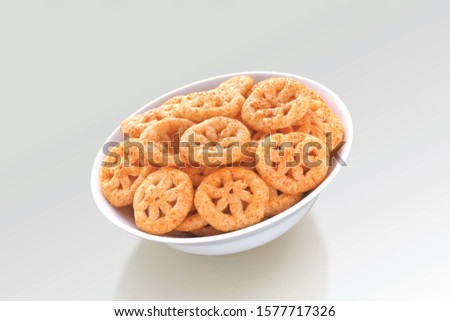 Fried and Spicy wheel Snacks or Fryums (Snacks Pellets) served in a bowl or White background. selective focus - Image Royalty-Free Stock Photo #1577717326