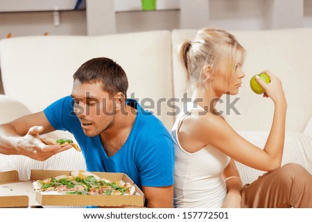 healthy and unhealthy nutrition concept - bright picture of couple eating different food