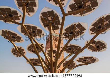 Solar cells, Koutoubia Mosque tower in downtown Marrakesh, Morocco, Africa. Eco, alternative energy, sustainable industry, ecosystem concepts. Solar panel, innovation, the transformation of energy. Royalty-Free Stock Photo #1577729698