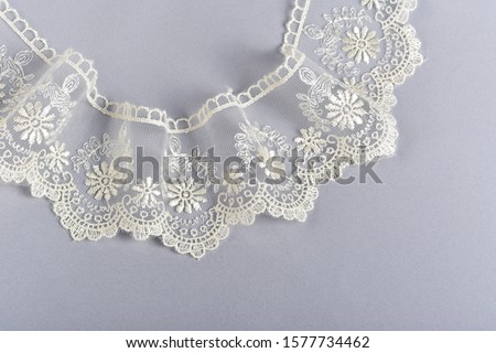 Texture ivory Delicate illuminating yellow gentle lace fabric on ultimate gray background