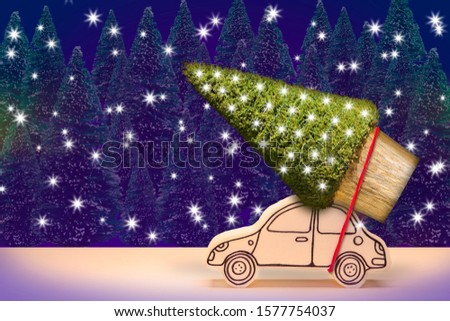 Christmas holiday concept with a small pine tree on handmade cartoon toy car
