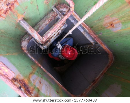 Pick up casualty from enclosed space by using rope. Vessels training and drill. PSC Concentrate Inspection Campaign.  Royalty-Free Stock Photo #1577760439