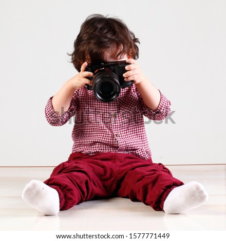 
Baby Sitting Taking Pictures on White Background