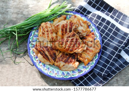 Chicken Legs Thighs Grilled On Blue Plate On Napkin With Fresh Green Onion. Flat Lay, Top View.