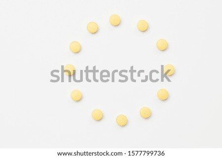 Orange pills on white background Royalty-Free Stock Photo #1577799736