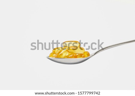 isolated fish oil on a spoon Royalty-Free Stock Photo #1577799742