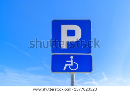 Big blue P sign for parking and parking sign for persons with disabilities