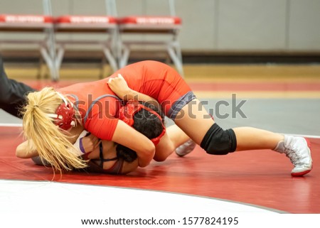 Girl High School wrestlers competing at a wrestling meet