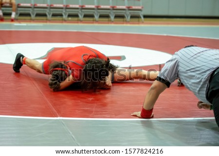 Girl High School wrestlers competing at a wrestling meet