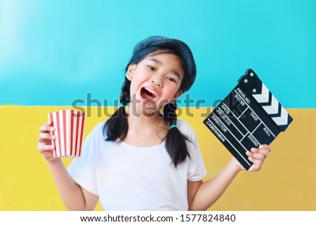 Happy Asian kid with clapper board.