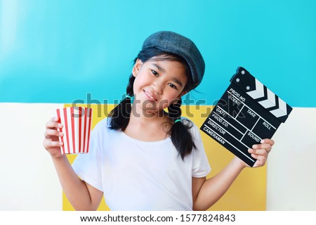 Happy Asian kid with clapper board.