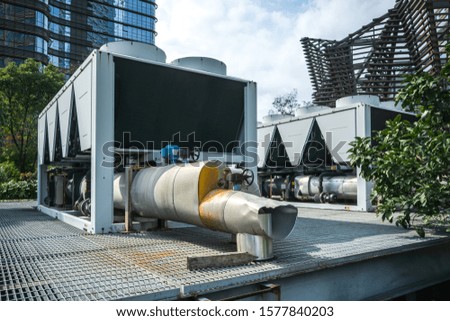Residential air conditioner compressor units near building