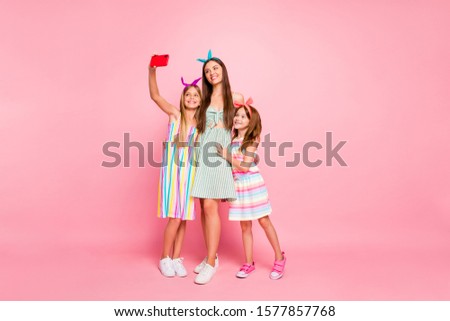 Full body photo of cute three people with long brunette blonde hair making selfie wearing skirt dress headbands isolated over pink background