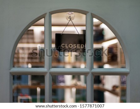closed sign hanging outside a restaurant, store, office or other
