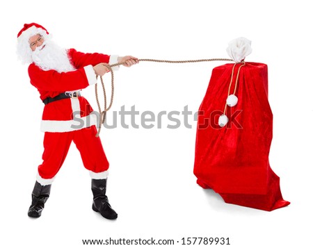Santa pulling gifts sack over white background