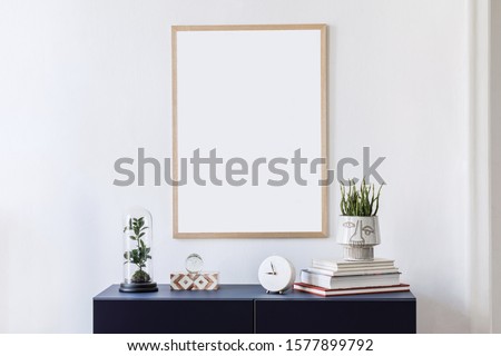 Stylish scandinavian living room with mock up poster frame, navy blue commode, plants, clocl and elegant accessories. Modern home decor. Interior design. Template Ready to use. 