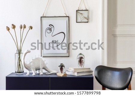 Stylish scandinavian living room with mock up photo frame, navy blue commode, table lamp, vase with flowers, chair and elegant accessories. Modern home decor. Interior design. Template Ready to use. 