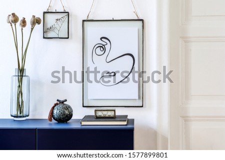 Modern scandinavian interior design with mock up photo frames, navy blue commode, flowers in vase and elegant accessories. Stylish home decor. Living room. Template Ready to use. 