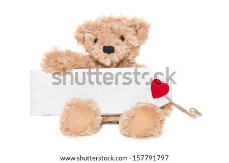 Christmas Teddy bear holding message with red heart isolated on white background