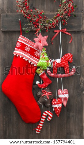 christmas decoration santa's sock and handmade toys over rustic wooden background. nostalgic retro style picture