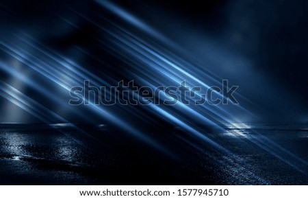 Empty night street scene. Dark street reflection of neon lights on wet asphalt. Rays of neon light in the dark. Abstract dark background. Night city.