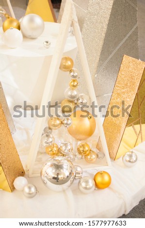Christmas gold and silver baubles with decoration forming an abstract background. Traditional christmas greeting card for the holiday season.