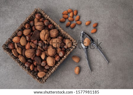 
Different types of nuts on a stone surface. Gray stone background. Top view.